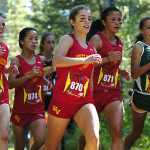 Ben Boettger/Peninsula Clarion Service High School varsity runner Bryn Waite (right) attempts to pass a pack from West Valley High School during the Tsalteshi Invitational Cross Country race at Skyview High School on Saturday, August 22.