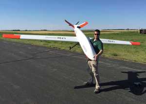 In this Aug. 4, 2015 photo provided by the University of North Dakota, UND pilot Schuyller "Sky" Andrew holds a Draganflyer X4ES drone that he flew on a test flight from the Lakota, N.D., airport that was conducted for the Northern Plains UAS Test Site. The North Dakota site has been granted approval by the Federal Aviation Administration to fly drones about 200 feet and fly them at night. It is the first of six national test sites to fly at night. (Andrew Regenhard/University of North Dakota via AP)