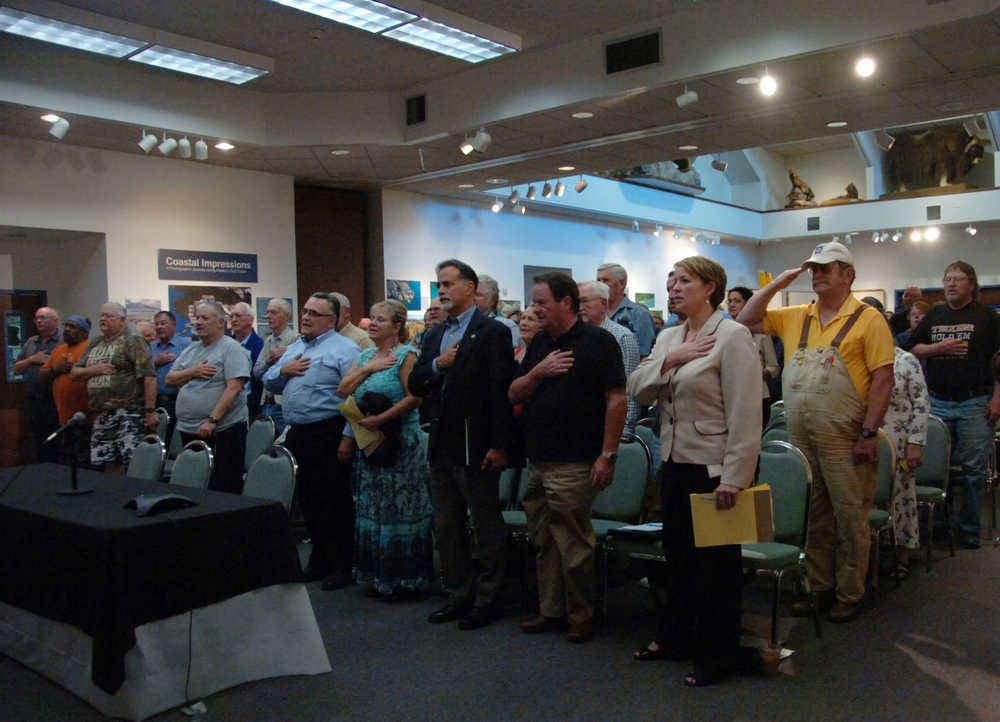 Photo by Megan Pacer/Peninsula Clarion Veterans and Veterans Affairs employees recite the Pledge of Allegiance before a VA listening session targeted at the Veterans Choice Act held Monday, Aug. 24 2015, at the Kenai Chamber of Commerce and Visitors Center in Kenai, Alaska.