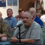 Photo by Megan Pacer/Peninsula Clarion Kenai resident Daniel Newman, a veteran suffering from stage three throat cancer, addresses Sen. Dan Sullivan and Veterans Affairs Under Secretary for Health Dr. David Shulkin during a VA listening session held Monday, Aug. 24 2015, at the Kenai Chamber of Commerce and Visitor Center in Kenai, Alaska.