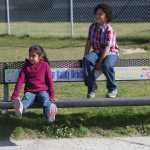 Photo by Kelly Sullivan/ Peninsula Clarion (Left) Angelina Llanez and Jebideth Martin watch the playground from the Buddy Bench before meeting a group of friends Friday, Aug. 28, 2015, at Nikiski North Star Elementary in Nikiski, Alaska.