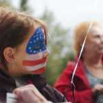 Ben Boettger/Peninsula Clarion Kyrie Cotton wears American flag facepaint during Kenai's Industry Appreciation Days on Saturday, August 29 at the Kenai Park Strip.