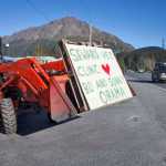 Photo by Rashah McChesney/Peninsula Clarion  A woman photographs an Osprey as it lands near Airport Road on Tuesday Sept. 1, 2015 in Seward, Alaska.