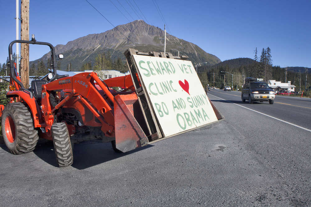 Photo by Rashah McChesney/Peninsula Clarion  A woman photographs an Osprey as it lands near Airport Road on Tuesday Sept. 1, 2015 in Seward, Alaska.