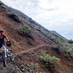 ADVANCE FOR WEEKEND OF AUG. 29-30, 2015. In this August 8, 2015 photo, Christine Simko walks along a trail on the Wrangell-St. Elias National Park and Preserve near McCarthy, Alaska. Depending on who you ask, the 9-mile round trip from Kennecott Mill Town to Bonanza Mine is either "an easy one" or "unrelenting." Similar sentiments could be applied to the nearby Jumbo Mine trip, which is one mile longer and rises 3,400 feet. (Robin Wood/Fairbanks Daily News-Miner via AP)