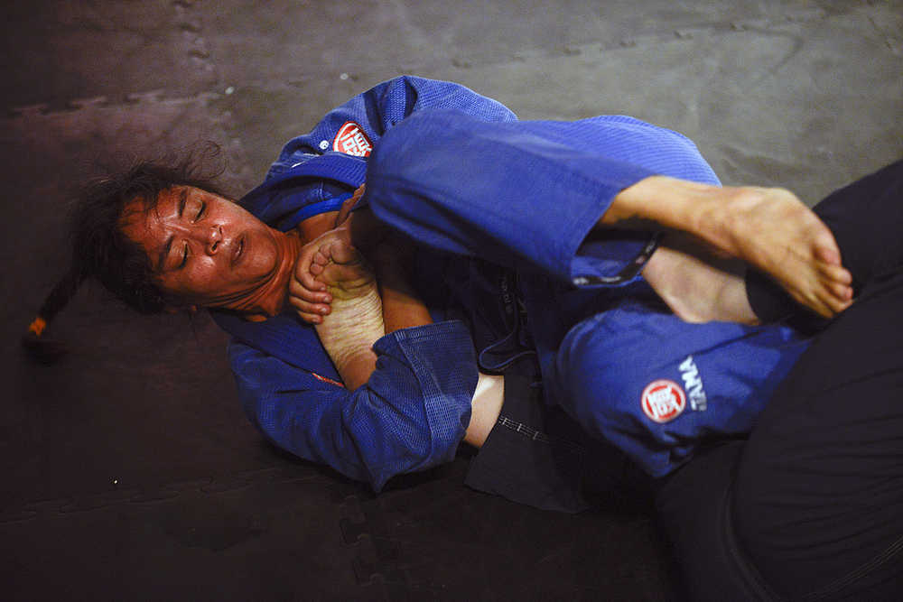 Photo by Rashah McChesney/Peninsula Clarion  Mae Britton gets a hold of Elisabeth Clay's foot during their exhibition on Saturday Sept. 5, 2015 for the Peninsula Fighting Championships mixed martial arts fights at the Peninsula Center Mall in Soldotna, Alaska.