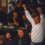 Photo by Rashah McChesney/Peninsula Clarion  Members of the audience cheer after Felix Bobby submits Cole Aquino during the first round of their fight on Saturday Sept. 5, 2015 at the Peninsula Center Mall in Soldotna, Alaska.