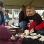 Photo by Megan Pacer/Peninsula Clarion Kenai resident Tony Perez, 8, slides down the end of an inflatable obstacle course on Monday, Sept. 7, 2015, at this year's Labor Day Picnic at Kenai Central Highschool in Kenai, Alaska.