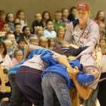 Ben Boettger/Peninsula Clarion U.S Olympic Women's Sevens Rugby player Alev Kelter (in red cap) directs a scrum made of Mountain View Elementary students and her team mates Amy Naber and Meya Bizer during a presentation on Wednesday, September 9 at Mountain View Elementary School.
