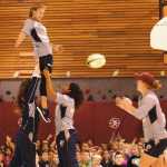 Ben Boettger/Peninsula Clarion Hoisted by her team mates Meya Bizer (left) and Amy Naber, U.S Olympic Rugby Sevens player Richelle Stephen returns a line-out pass to Alev Kelter during a presentation to students on Wednesday, September 9 at Mountain View Elementary School in Kenai.