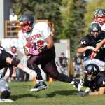 Ben Boettger/Peninsula Clarion  evades tacklers at a game against Nikiski on Saturday, September 12 at Nikiski High School.