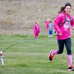 Photo by Megan Pacer/Peninsula Clarion A runner and her dog cross the finish line at the Making Strides Against Breast Cancer Walk/Run on Sunday, Sept. 13, 2015 at the Tsalteshi Trails in Soldotna, Alaska.
