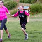 Photo by Megan Pacer/Peninsula Clarion Soldtona resident April Chilton crosses the finish line of the Making Strides Against Breast Cancer Walk/Run with her 13-year-old son, Lance, who looped back to join her after finishing the 5K first, on Sunday, Sept. 13, 2015 at the Tsalteshi Trails in Soldotna, Alaska.