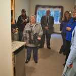 Photo by Rashah McChesney/Peninsula Clarion  Jim McCall, senior housing officer at the Alaska Housing Finance Corporation and Amanda Lofgren, program officer at the Alaska Mental Health Trust Authority talk to Shery Mettler, executive director of the Riverside Assisted Living facility during a Commission on Aging tour on Wednesday Sept. 16, 2015 in Soldotna, Alaska. The commission is touring several facilities on the Kenai Peninsula as part of its rural outreach meeting.