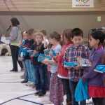 Photo by Megan Pacer/Peninsula Clarion Students who kept a log of what the read over the summer recieve books, a t-shirt and other prizes on Friday, Sept. 18, 2015 during a RIGS assembly at Kalifornski Beach Elementary in Soldotna, Alaska.