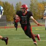 Ben Boettger/Peninsula Clarion Kenai Central High School Varsity football player Zach Tuttle runs with the ball during a game against Palmer High School on Saturday, Sept. 19 at Kenai Central High School.