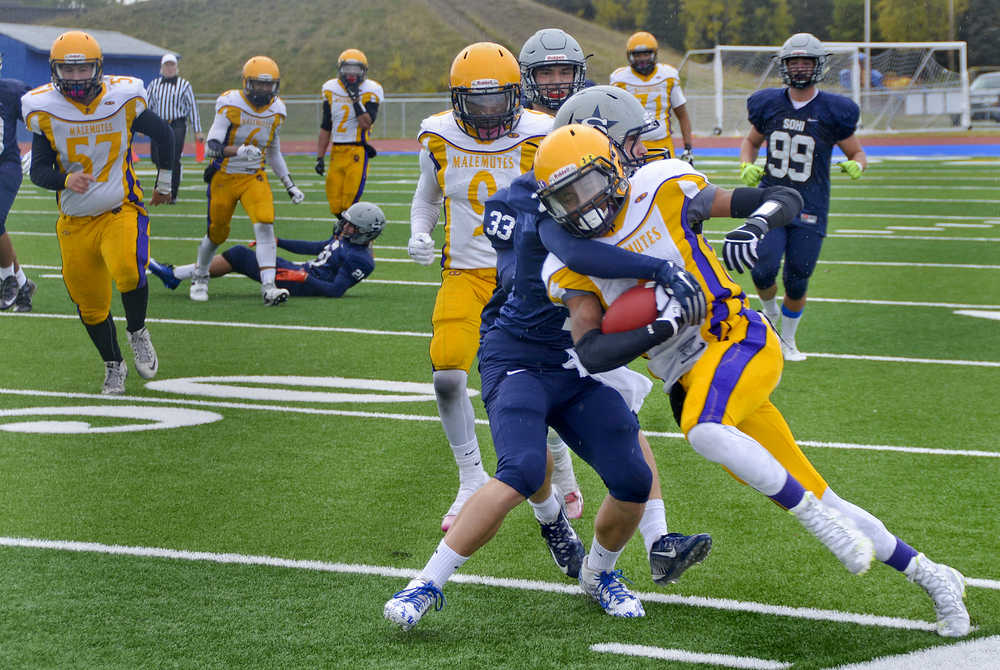Photo by Rashah McChesney/Peninsula Clarion Soldotna's Brandon Crowder tackles Lathrop's Ricardo Henry during their game on Saturday Sept. 26, 2015 in Soldotna, Alaska.
