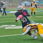 Photo by Rashah McChesney/Peninsula Clarion Soldotna High School's Keola Finau gets tackled by Lathrop's Garrius Maiden during their game on Saturday September 26, 2015 in Soldotna, Alaska.