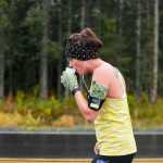 Photo by Rashah McChesney/Peninsula Clarion  Katie Evans pauses for a drink of water at a station on Poppy Lane on Sunday Sept. 27, 2015 near Soldotna, Alaska. Evans finished 38th out of the 54 runners registered for the marathon.