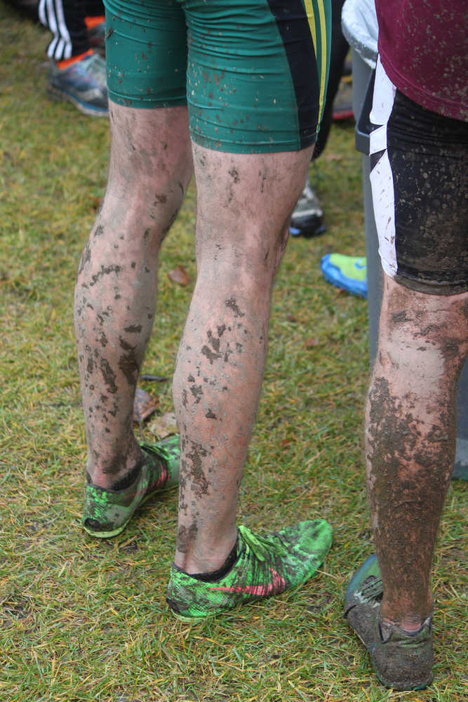 Photo by Joey Klecka/Peninsula Clarion Mud adorns the legs of Seward junior Hunter Kratz after Saturday's Class 123A boys state championship race at Bartlett High School in Anchorage. Kratz finished second to lead the Seward boys.