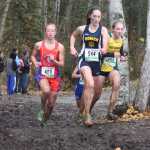 Photo by Joey Klecka/Peninsula Clarion Homer junior Megan Pitzman (544) leads Anchorage Christian's Elizabeth Balsan (408) and Seward's Ruby Lindquist (703) in Saturday's Class 123A girls state championship race at Bartlett High School in Anchorage. The Homer girls won their second straight cross-country team championship and fifth in school history.