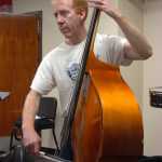 Photo by Megan Pacer/Peninsula Clarion Kent Peterson plays the string bass during a Kenai Peninsula Orchestra practice on Thursday, Oct. 1, 2015 at Kenai Central High School.