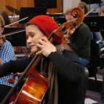 Photo by Megan Pacer/Peninsula Clarion Soldotna resident Emily Grossman plays the cello during a Kenai Peninsula Orchestra practice on Thursday, Oct. 1, 2015 at Kenai Central High School.