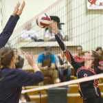 Ben Boettger/Peninsula Clarion Kenai's Alexis Baker gets ball over the net, with Soldotna's Drew Zeek and Sylvia Tuisaula blocking during a game  on Friday, Oct. 9 at Kenai Central High School.