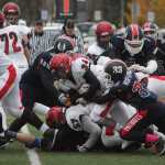 Photo by Joey Klecka/Peninsula Clarion With help from senior lineman Zach Koziczkowski (57), Kenai senior Draiden McMinn (34) carries the football into the endzone last Saturday against North Pole at Dimond Alumni Field in Anchorage.