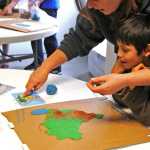 Odin Sallison and his mother work on his project building the country of Brazil out of clay for the IDEA homeschool group's geography club meeting Friday.