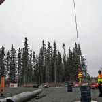 Bill Elmore and Daniel Barry watch and time Brandon Leary as he attempts to lower the auxiliary ball of a crane into a barrel, one of the certification practical exam requirements.