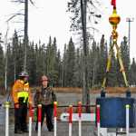 Bill Elmore and Daniel Barry watch as Brandon Leary completes the "zigzag test," in which he must navigate a test weight through a course while avoiding the poles.