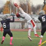 Kenai's Zack Tutle catches a touchdown pass between Soldotna's Dylan Simons, 5 and Jesse Littrel.  Photo for the Clarion by Michael Dinneen