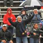 Patsy Tuisaula, center, cheers on her son Wendell, with husband Wendell Sr. and niece Akina Pasa.  Photo for the Clarion by Michael Dinneen
