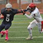 Soldotna's Jesse Littrel stiff arms Kenai's Keith Ivy on a kickoff return.  Photo for the Clarion by Michael Dinneen