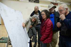Photo by Megan Pacer/Peninsula Clarion Sterling residents gather around a map of the community to add black dots to indicate locations where thefts or burglaries have occurred. The map was presented at a community meeting on Saturday, Oct. 10, 2015 at the Sterling Community Center where about 100 people came to listen to their options for protecting against property crimes.