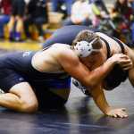 Photo by Kelly Sullivan/ Peninsula Clarion In this November 15, 2014 file photo, Nikiski Bulldogs' Luke Johnson in the 220-pound weight class tries to push Soldotna Stars' Taylor Macree's head to the mat at Nikiski High-Middle School in Nikiski, Alaska.
