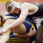 Photo by Kelly Sullivan/ Peninsula Clarion In this Nov. 25, 2014 file photo, Nikiski Bulldog TJ Cox tries to pin Homer Mariner Jared Brant in the 120-pound weight class match during the Luke Spruill Memorial Wrestling Tournament at Kenai Central High School in Kenai, Alaska.