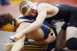 Photo by Kelly Sullivan/ Peninsula Clarion In this Nov. 25, 2014 file photo, Nikiski Bulldog TJ Cox tries to pin Homer Mariner Jared Brant in the 120-pound weight class match during the Luke Spruill Memorial Wrestling Tournament at Kenai Central High School in Kenai, Alaska.