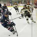 Ben Boettger/Peninsula Clarion  moves the puck, chased by  at a hockey game on Friday Oct. 23 at the Soldotna Sports Center.