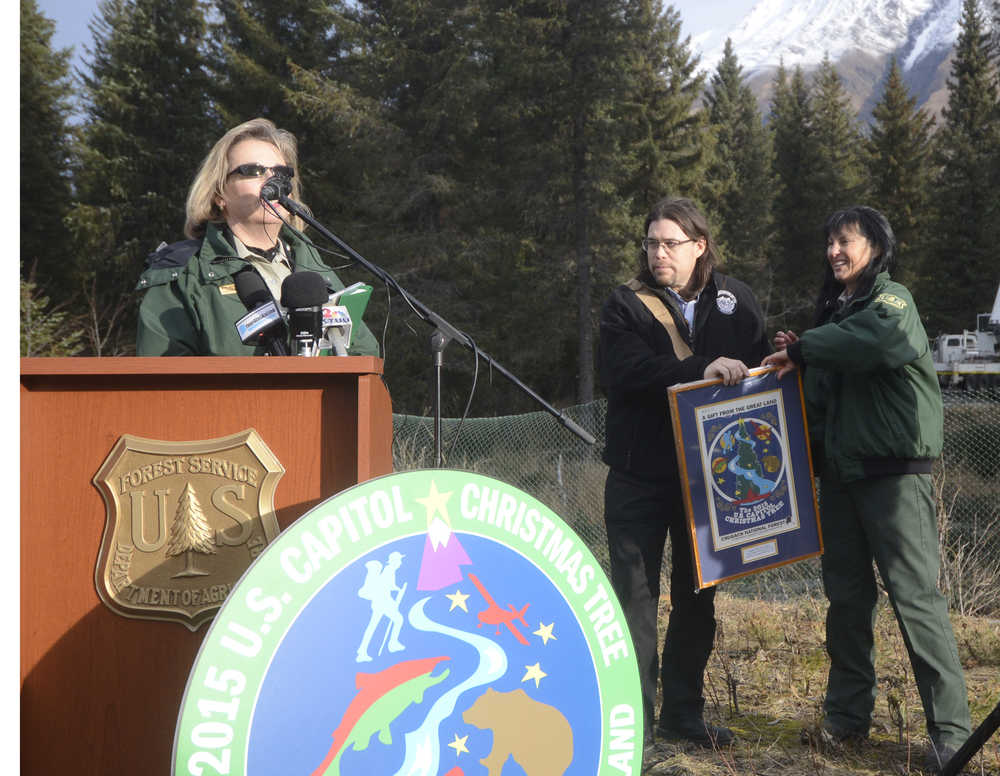 Photo by Megan Pacer/Peninsula Clarion Regional Forester Beth Pendleton, left, and Chugach Forest Supervisor Terri Marceron, right, present Kenaitze Indian Tribe Member Jon Ross with gifts after his blessing of the 2015 U.S. Capitol Christmas Tree on Tuesday, Oct. 27, 2015 at the Chugach National Forest near Seward, Alaska.