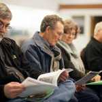 Photos by Rashah McChesney/Peninsula Clarion A handful of the more than 80 people who attended a Federal Energy Regulatory Commission read through a handout from the Alaska LNG project during the meeting on Wednesday October 27, 2015 in Nikiski, Alaska.