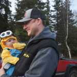 Photo by Megan Pacer/Peninsula Clarion Soldotna resident Austin Bundy holds his nearly 6-month-old son, Sullivan, while walking along the Tsalteshi Trails during the 2015 Spook Night Trick or Treat and Zombie 5K on Sunday, Oct. 25, 2015 in Soldotna, Alaska.