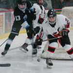 Photo by Kelly Sullivan/ Peninsula Clarion In this Jan. 9, 2015 file photo, Kenai Central High School's Ian Mercado controls the puck after a scuffle by the goal in the game against Chugiak High School at the Soldotna Regional Sports Complex in Soldotna, Alaska.