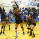 Ben Boettger/Peninsula Clarion Soldotna volleyball players Kearstin Yarnes (left) and Drewe Zeek leap to block a volley by Kenai's Abby Beck during a game at Soldotna High School on Friday, Oct. 30.