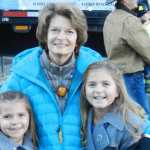 Anna DeVolld writes a message on the trailer that will haul the Capitol Christmas tree from Alaska to Washington, D.C. (Courtesy photo)