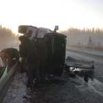 Photo by Megan Pacer/Peninsula Clarion Members of Soldotna Y Towing prepare to haul a pickup truck off the road around mile 8 of the Kenai Spur Highway after its driver struck the guard rail on Tuesday, Nov. 3, 2015 in Kenai, Alaska. The driver was taken to Central Peninsula Hospital to be treated for injuries.