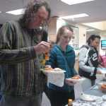 Photo by Megan Pacer/Peninsula Clarion Barnie Weaver, of Kasilof, puts honey on a piece of fry bread during a kick-off event for Alaska Native/Native American Heritage Month on Thursday, Nov. 5, 2015, in the McLane Commons at Kenai Peninsula College.