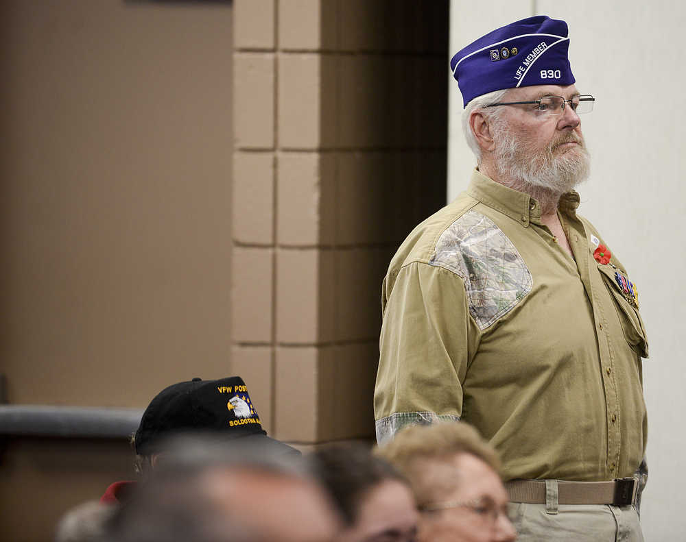Photo by Rashah McChesney/Peninsula Clarion  Nearly 100 people stood - many saluted - as the colors were retired during a Veterans Day ceremony on Wednesday Nov. 11, 2015 in Soldotna, Alaska.
