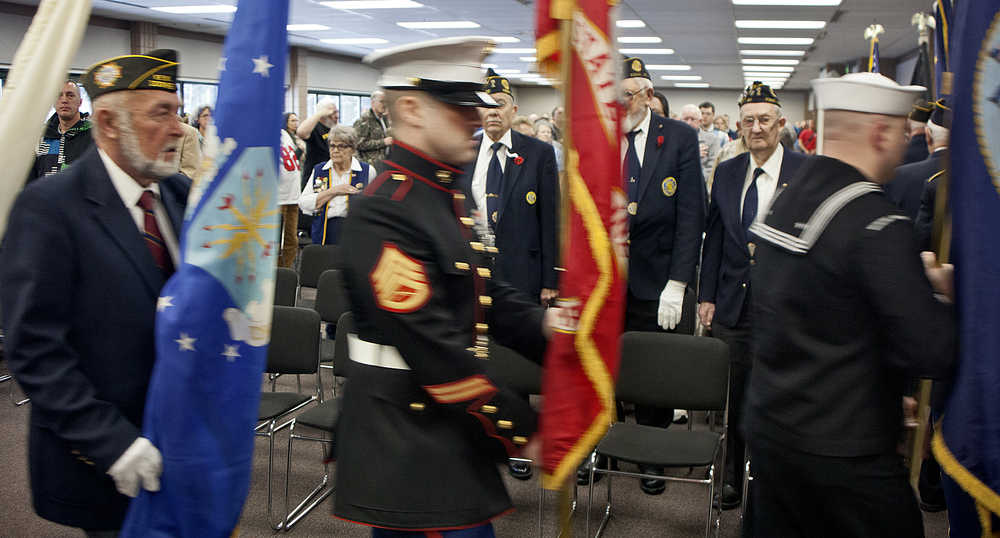 Photo by Rashah McChesney/Peninsula Clarion An audience member watches the color guard before a Veterans Day ceremony on Wednesday Nov. 11, 2015 in Soldotna, Alaska.